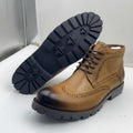 Premium tan leather upper with dark burnished toe finish, brogue detailing, and rugged black lug sole